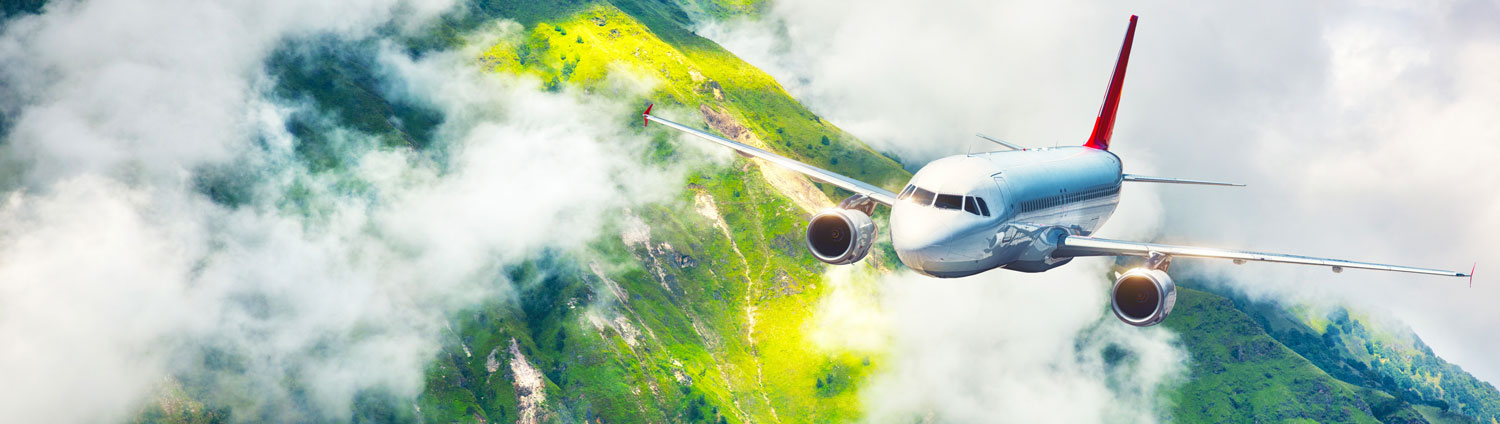airplane flying over the mountains in clouds