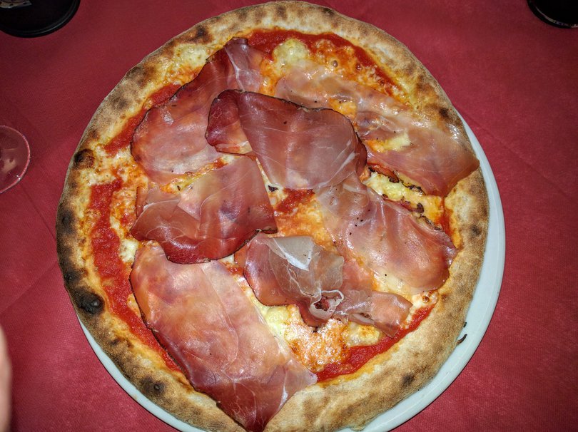 Delicious Italian pizza with cured ham