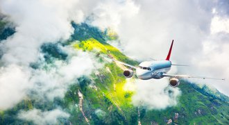 airplane flying over the mountains in clouds