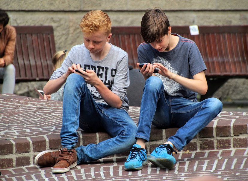 Friends looking at their smartphones instead of talking