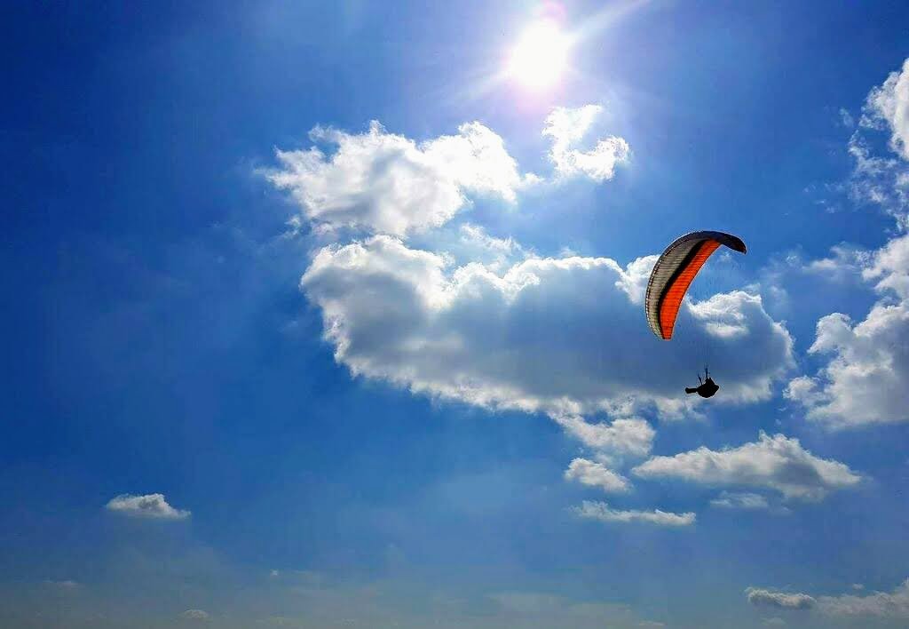 Paraglider high up in the sky